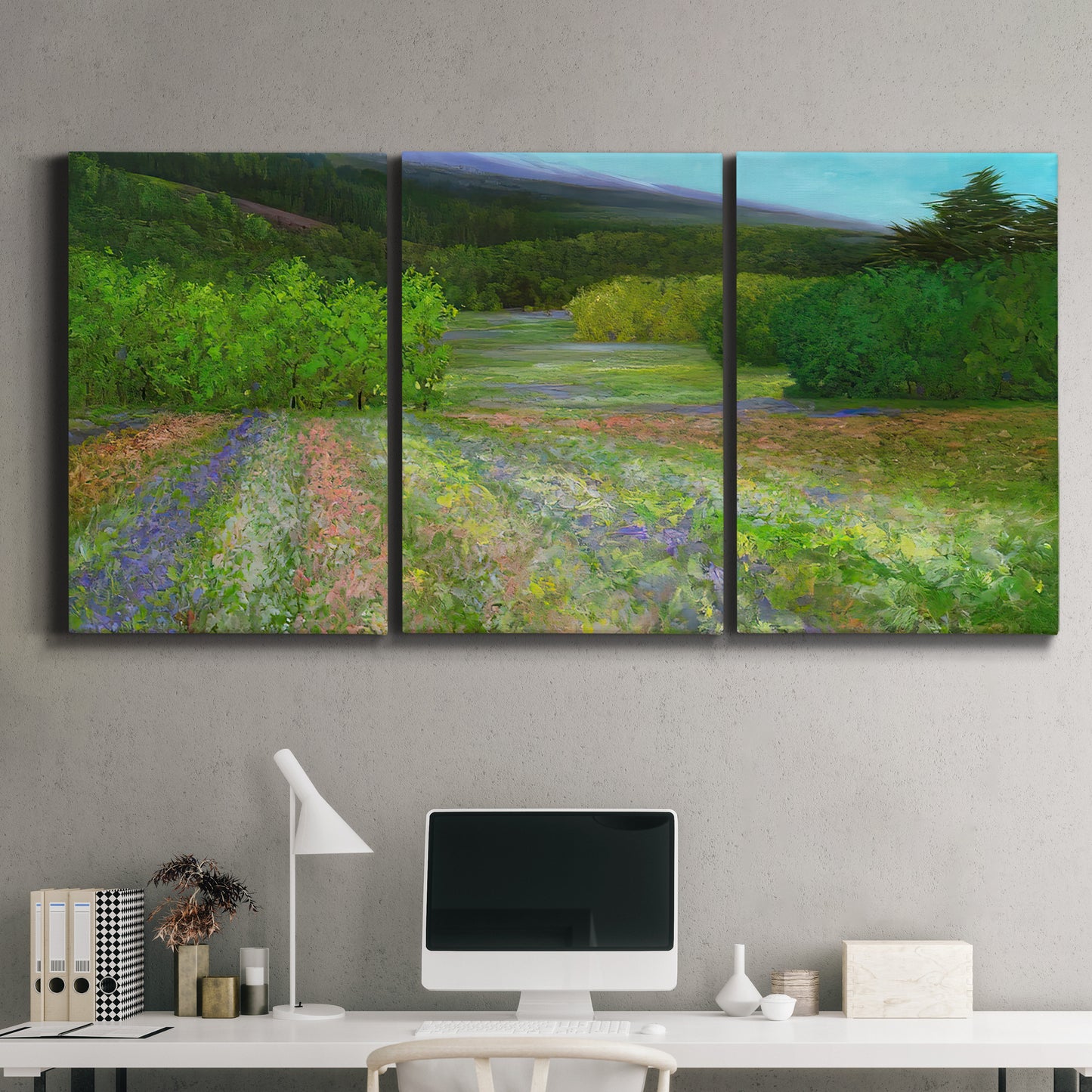 Three-panel canvas wall art featuring fresh spring meadow landscape, displayed above a desk in a home office.