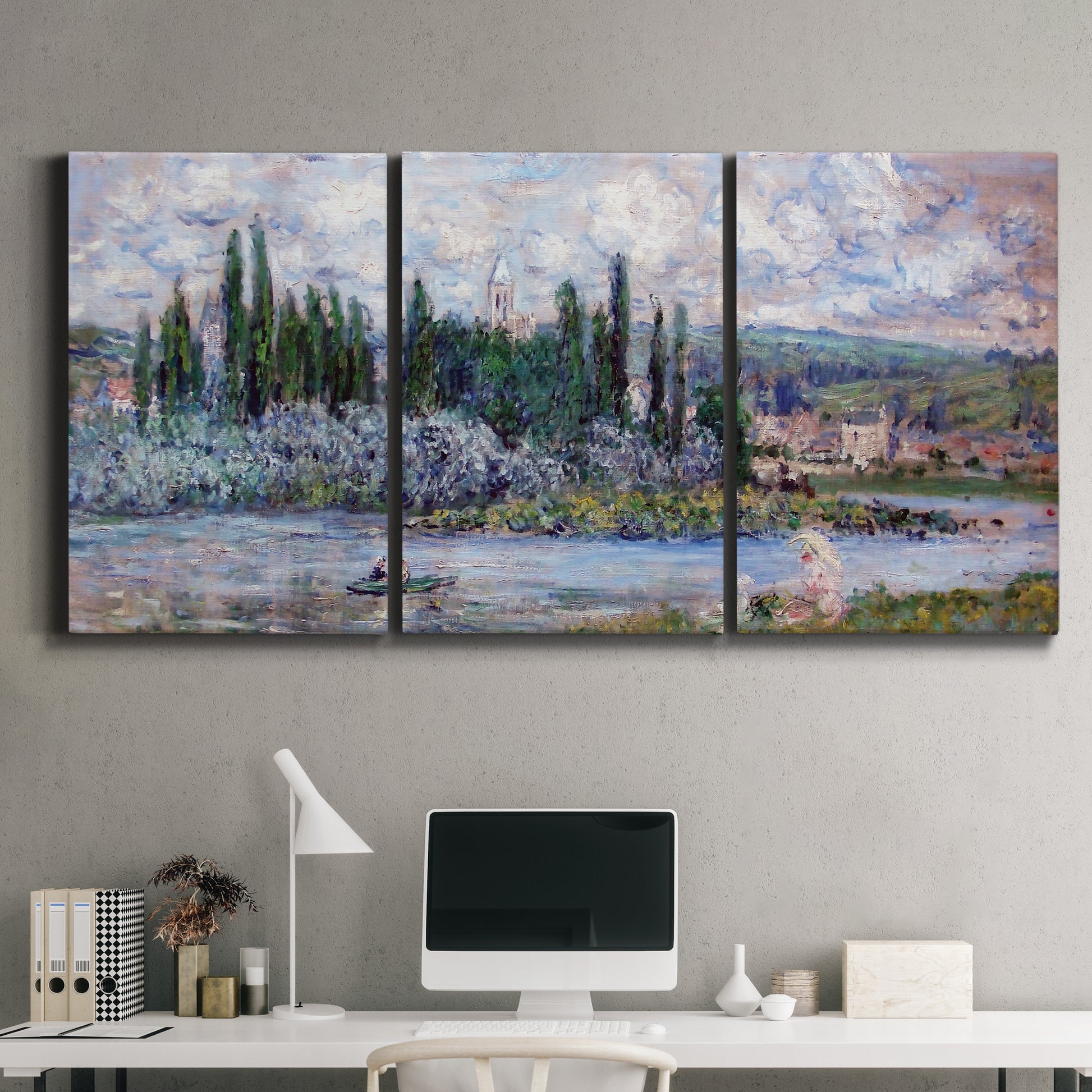 Three-panel canvas wall art featuring summer village view along river, displayed above a desk in a home office.