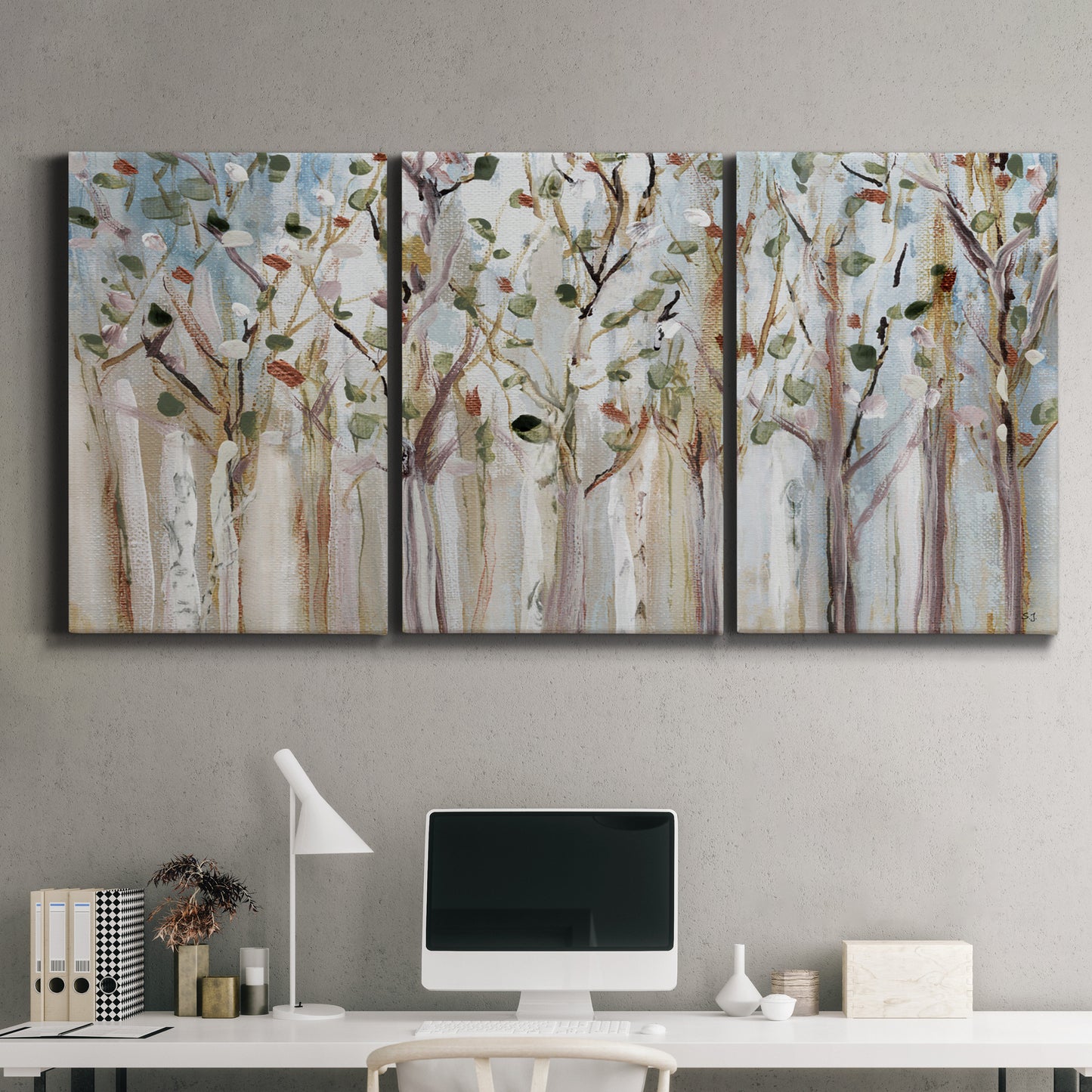 Three-panel canvas wall art featuring bare birch trees in winter forest, displayed above a desk in a home office.