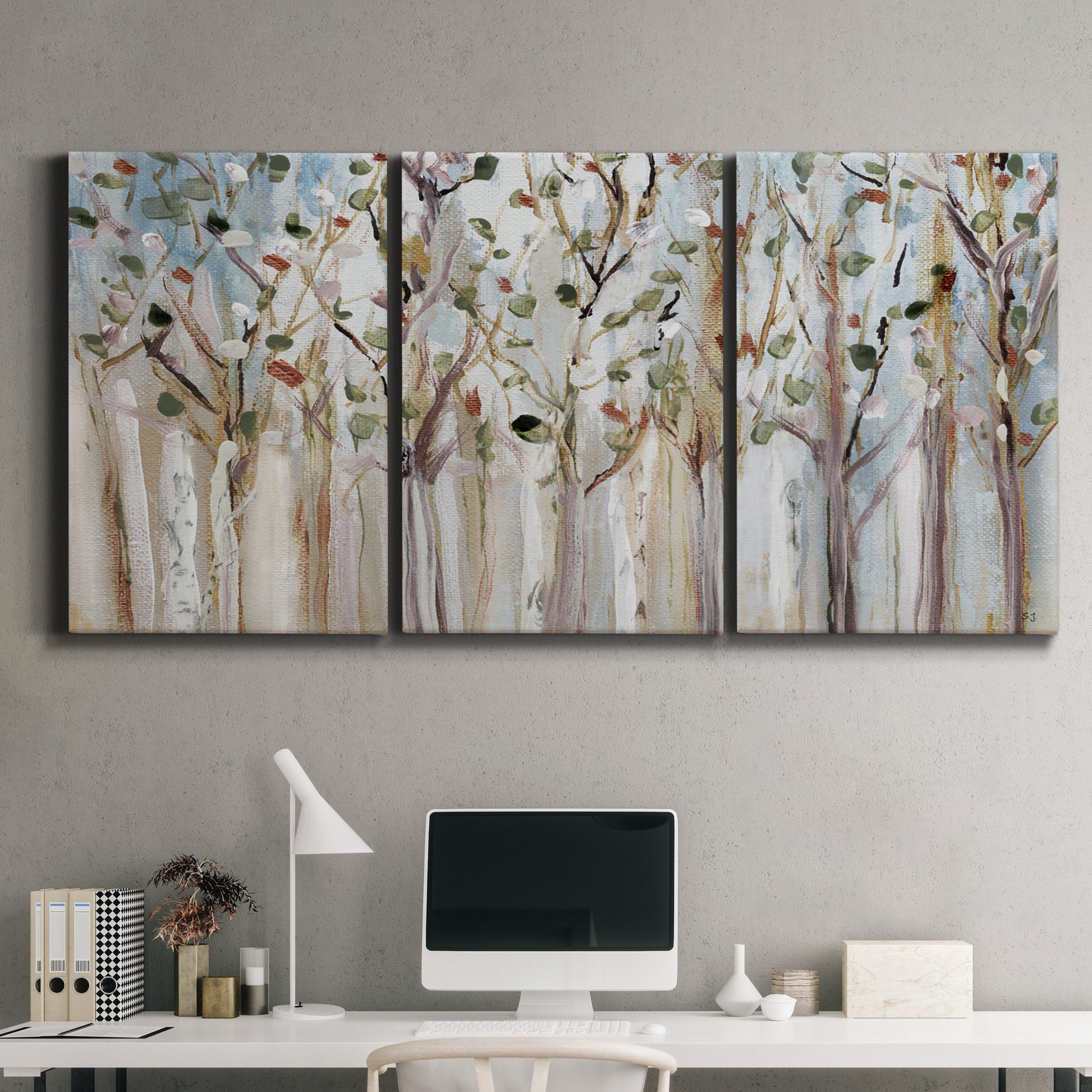 Three-panel canvas wall art featuring bare birch trees in winter forest, displayed above a desk in a home office.