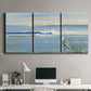 Three-panel canvas wall art featuring sunrise reflecting across bay waters, displayed above a desk in a home office.
