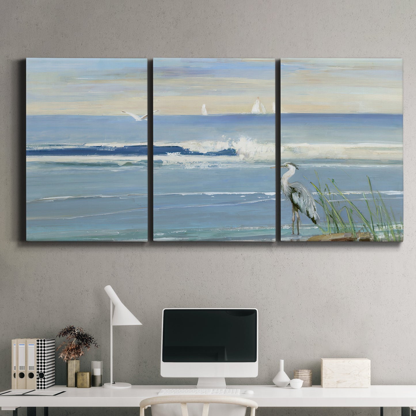 Three-panel canvas wall art featuring sunrise reflecting across bay waters, displayed above a desk in a home office.