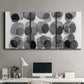 Three-panel canvas wall art featuring geometric abstract watercolor forms, displayed above a desk in a home office.