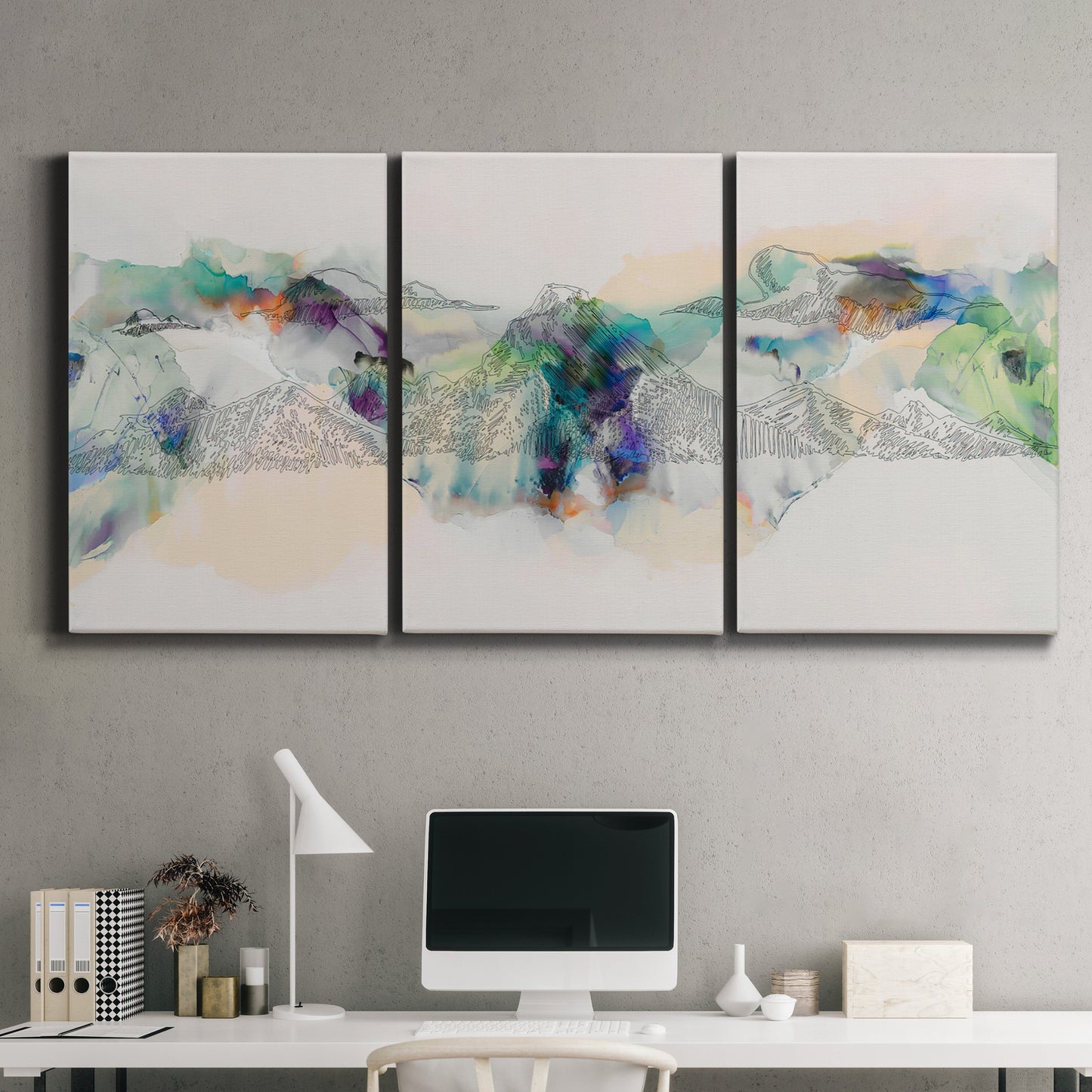 Three-panel canvas wall art featuring abstract mountain range watercolor, displayed above a desk in a home office.