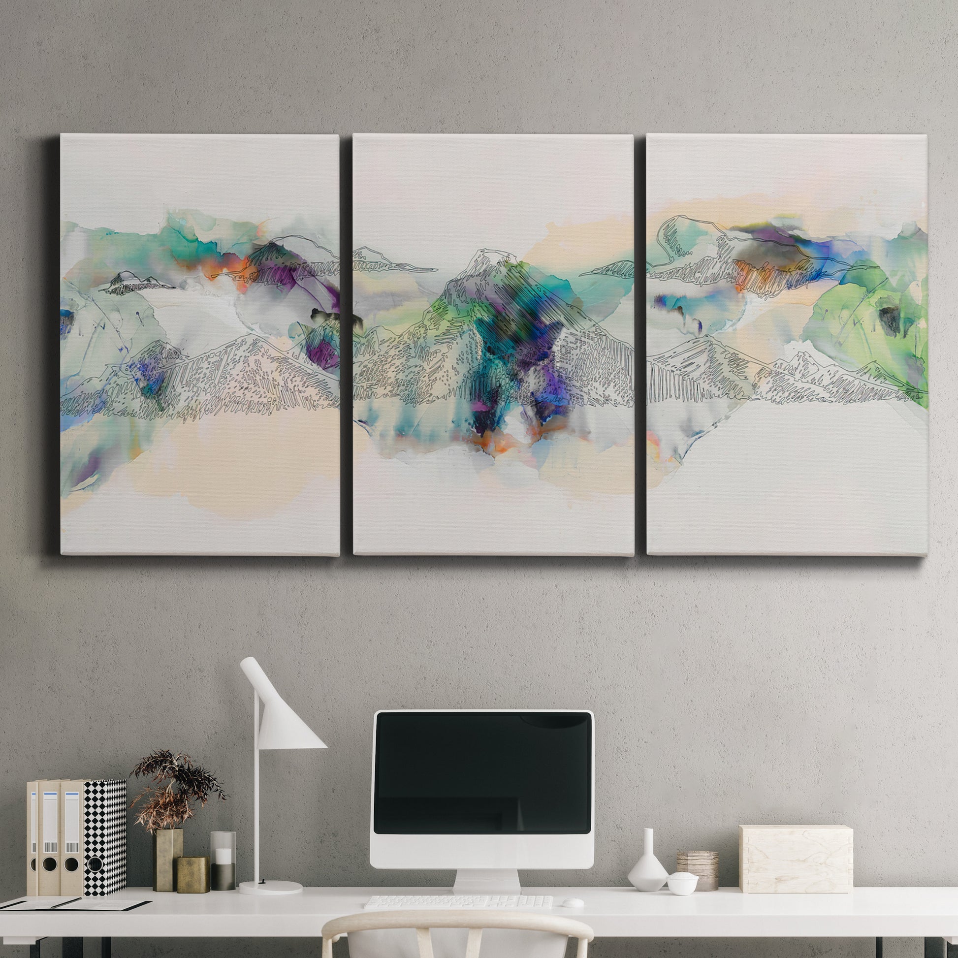 Three-panel canvas wall art featuring abstract mountain range watercolor, displayed above a desk in a home office.