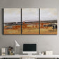 Three-panel canvas wall art featuring abstract bridge landscape in ochre, displayed above a desk in a home office.
