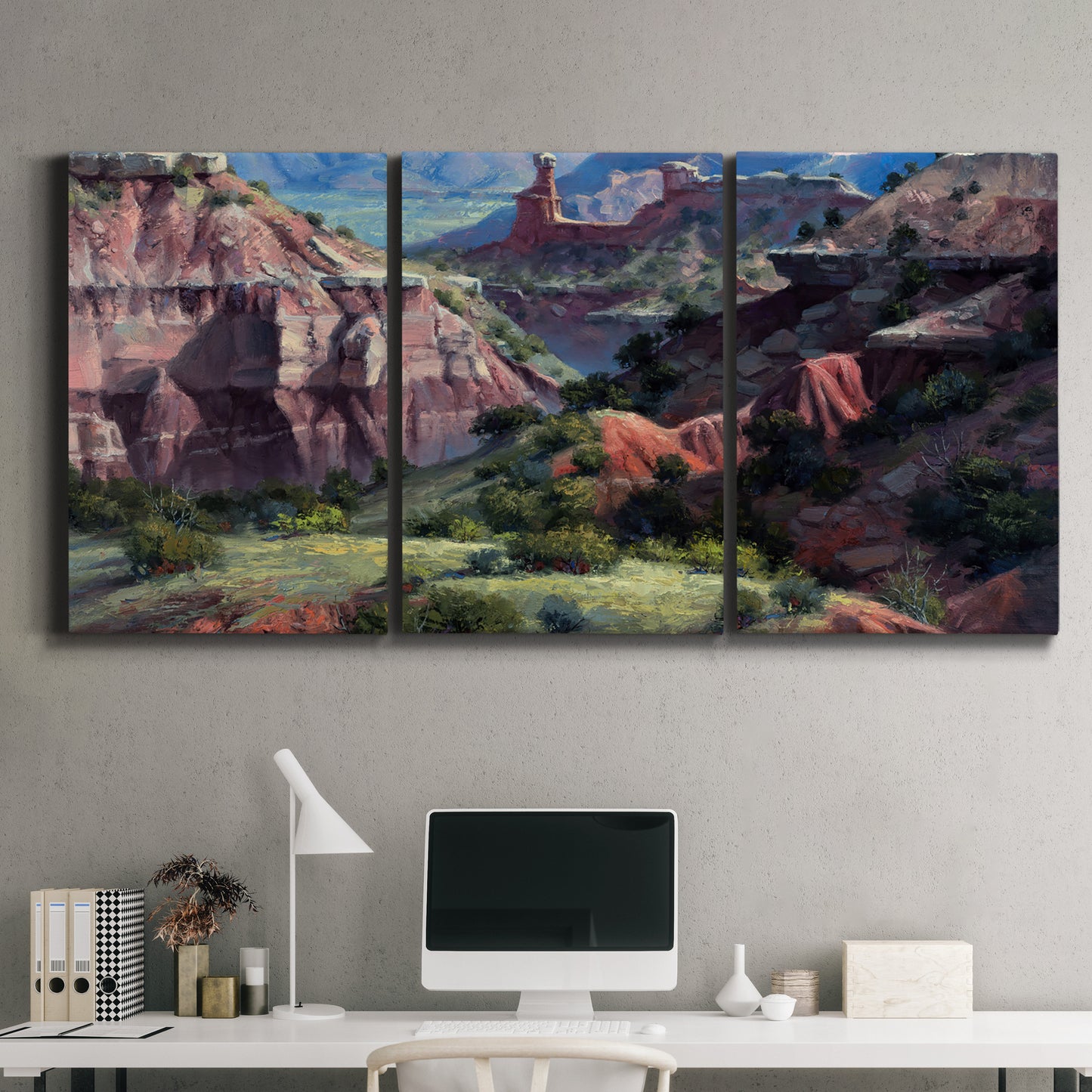 Three-panel canvas wall art featuring classic canyon landscape scene, displayed above a desk in a home office.