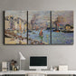 Three-panel canvas wall art featuring evening harbor with reflections, displayed above a desk in a home office.