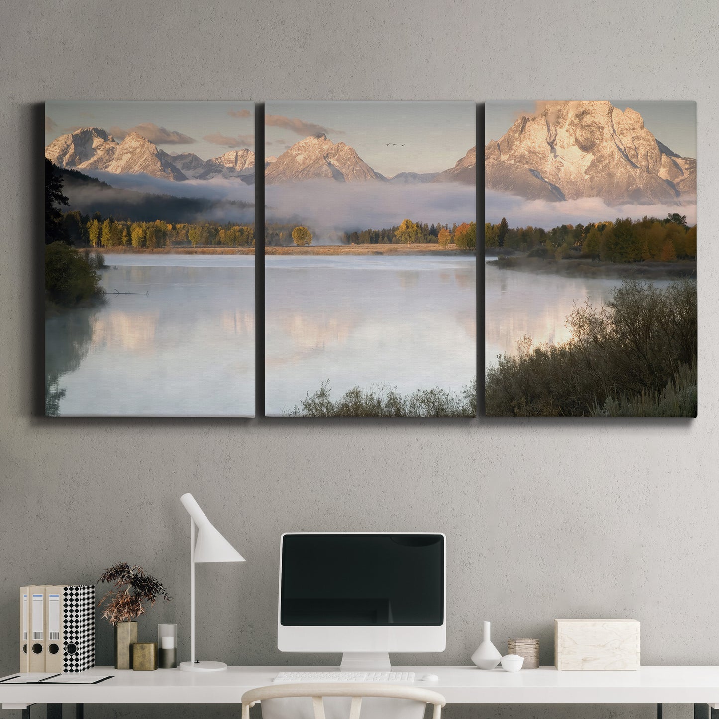 Three-panel canvas wall art featuring fog drifting over winding river, displayed above a desk in a home office.