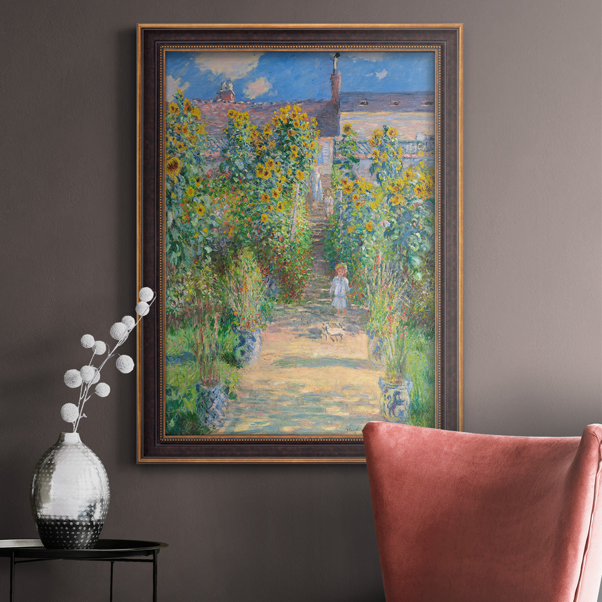 Impressionist garden landscape painting by Claude Monet in an ornate bronzed mahogany wood frame displayed in a neutral interior setting.