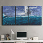 Three-panel canvas wall art featuring sailboats moving across water, displayed above a desk in a home office.