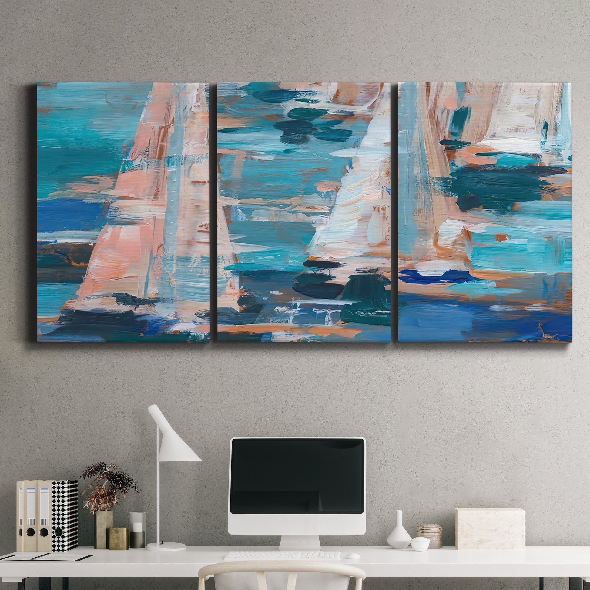 Three-panel canvas wall art featuring graphic pop style sailboats, displayed above a desk in a home office.