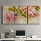 Three-panel canvas wall art featuring soft floral blossom composition, displayed above a desk in a home office.