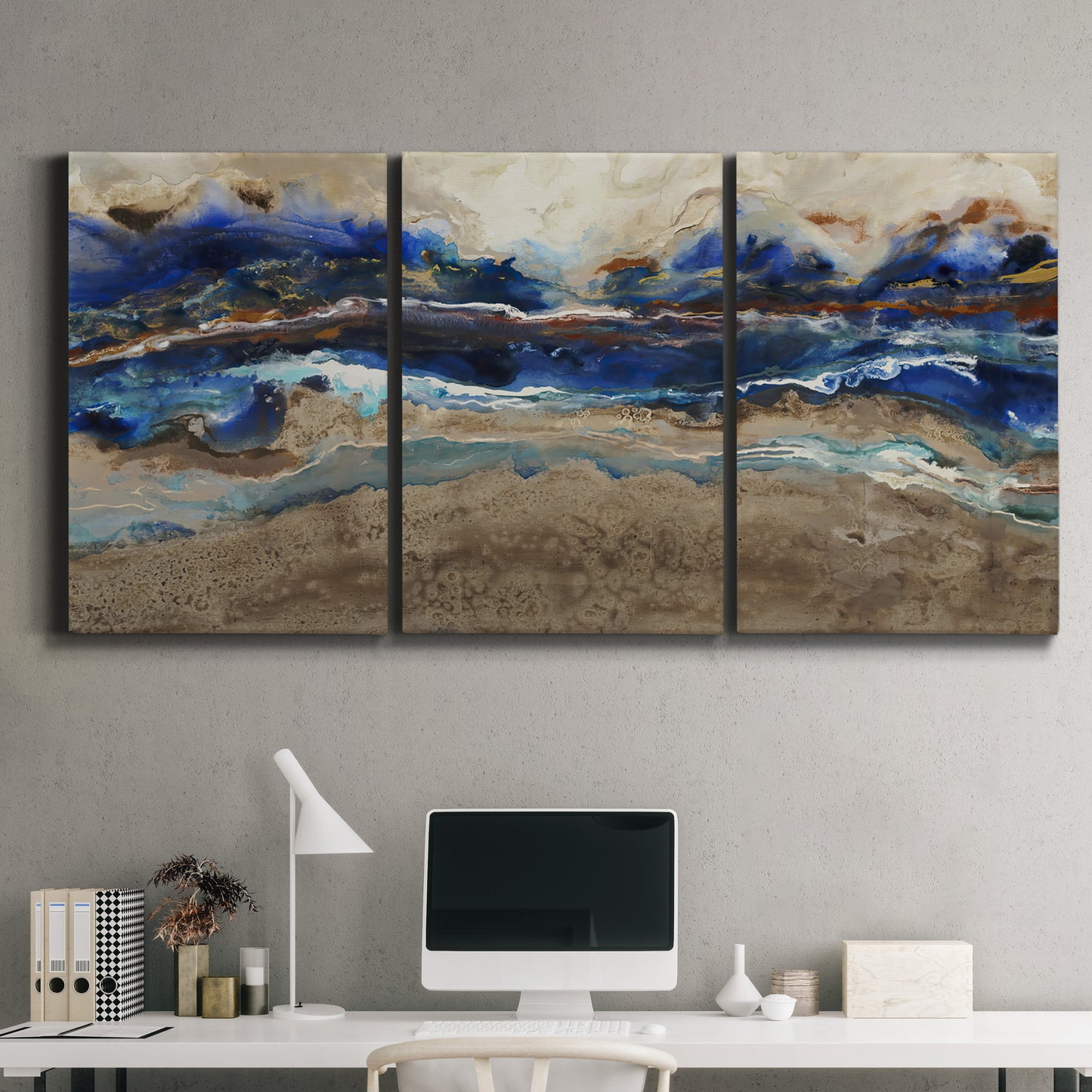 Three-panel canvas wall art featuring abstract coastal jewel toned composition, displayed above a desk in a home office.