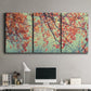 Three-panel canvas wall art featuring autumn foliage landscape photograph, displayed above a desk in a home office.