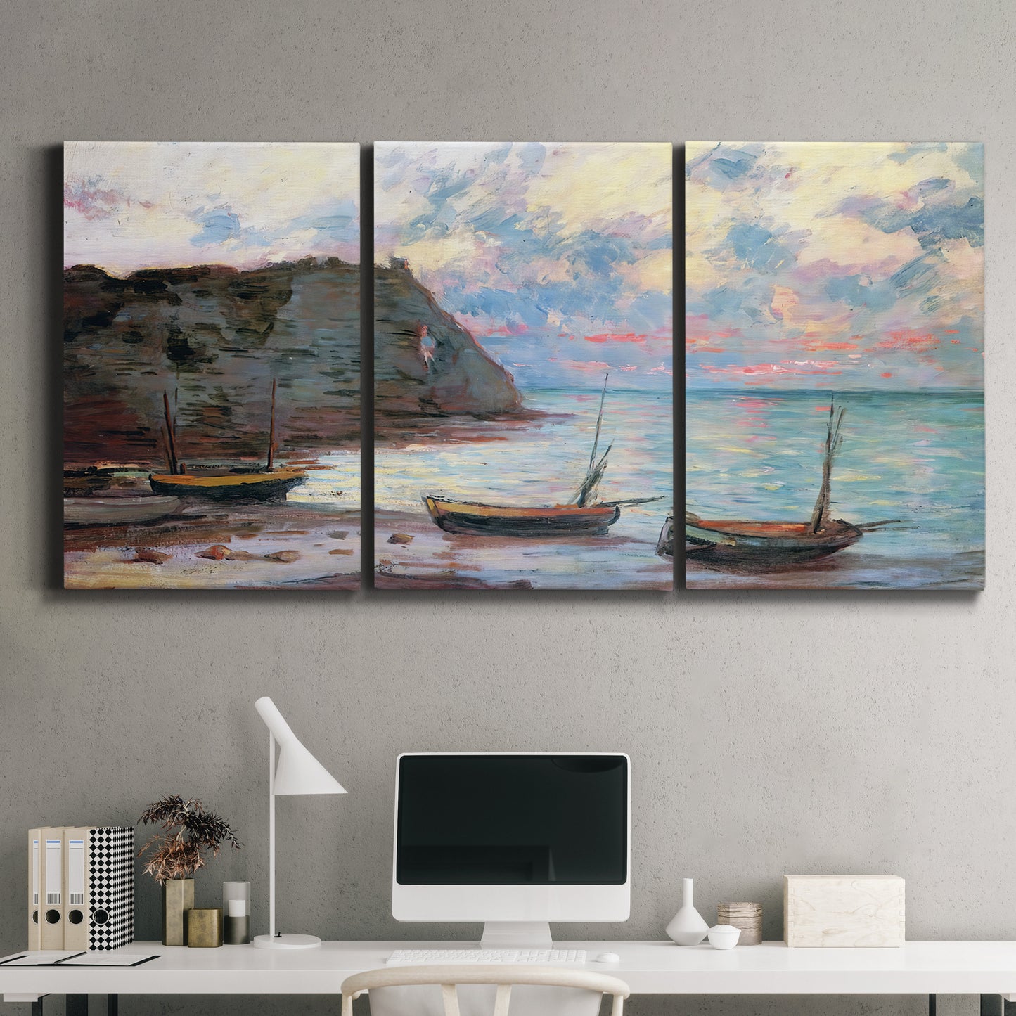 Three-panel canvas wall art featuring golden coastal sunset with cliffs, displayed above a desk in a home office.