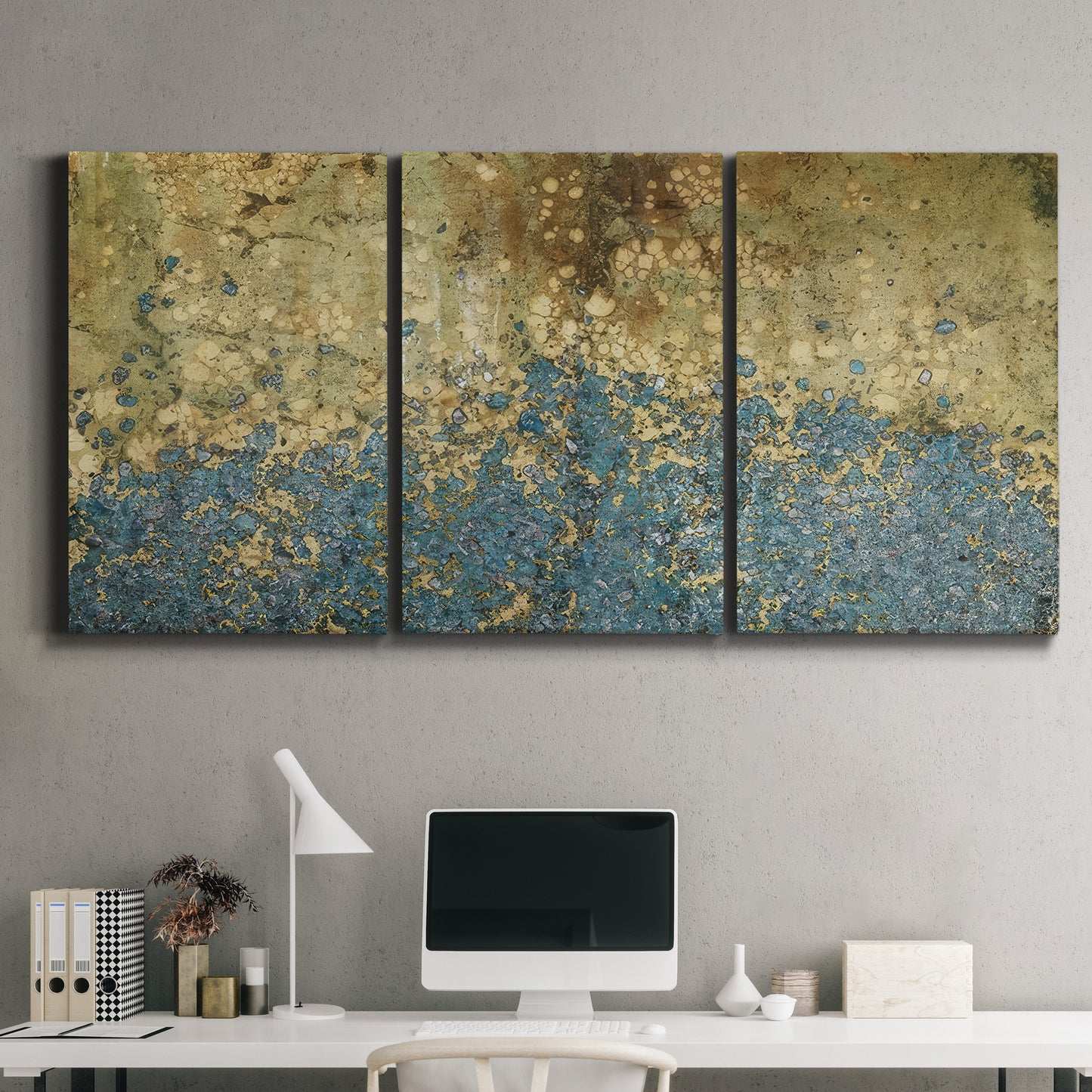 Three-panel canvas wall art featuring metallic abstract gold tones, displayed above a desk in a home office.