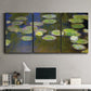 Three-panel canvas wall art featuring yellow and white water lilies, displayed above a desk in a home office.