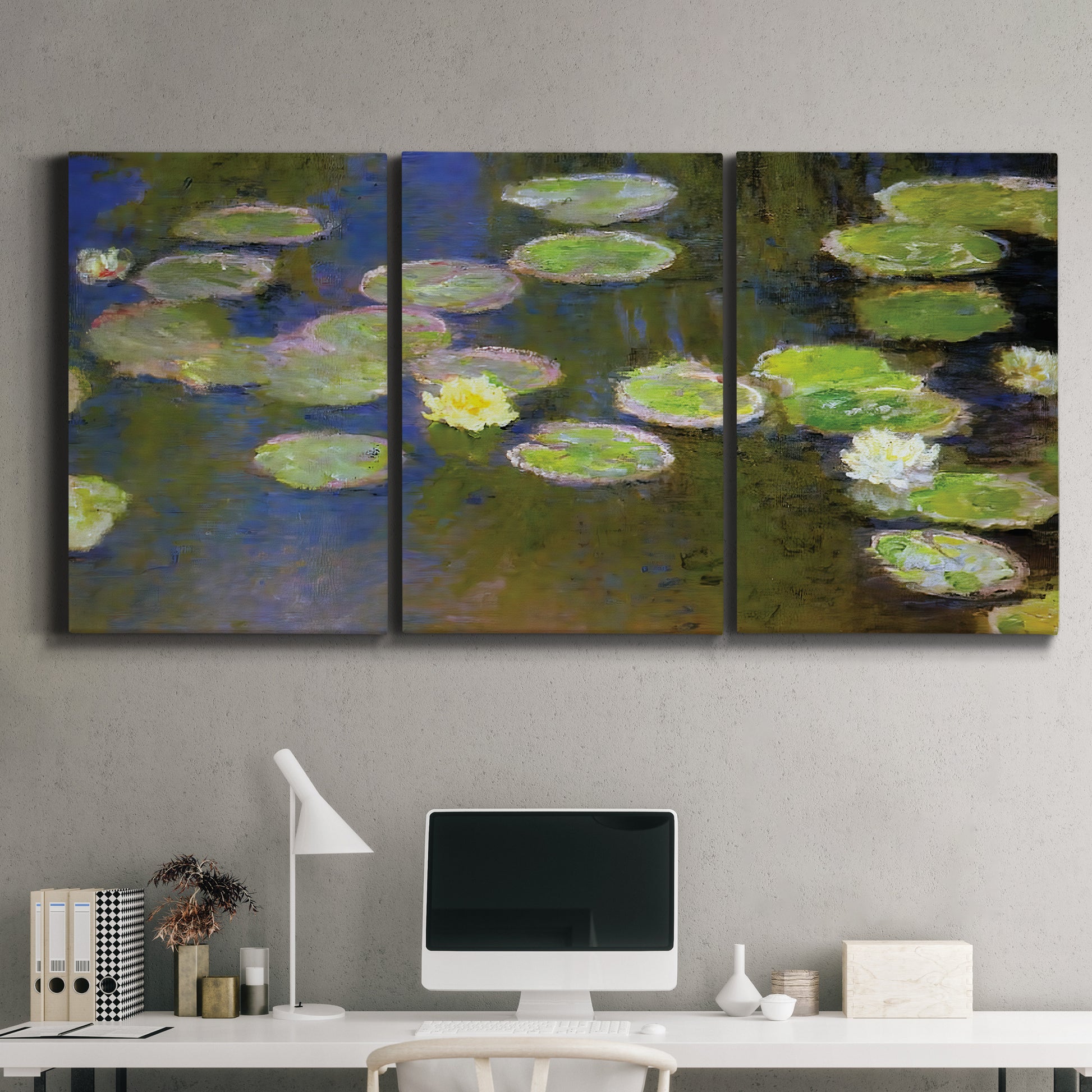 Three-panel canvas wall art featuring yellow and white water lilies, displayed above a desk in a home office.