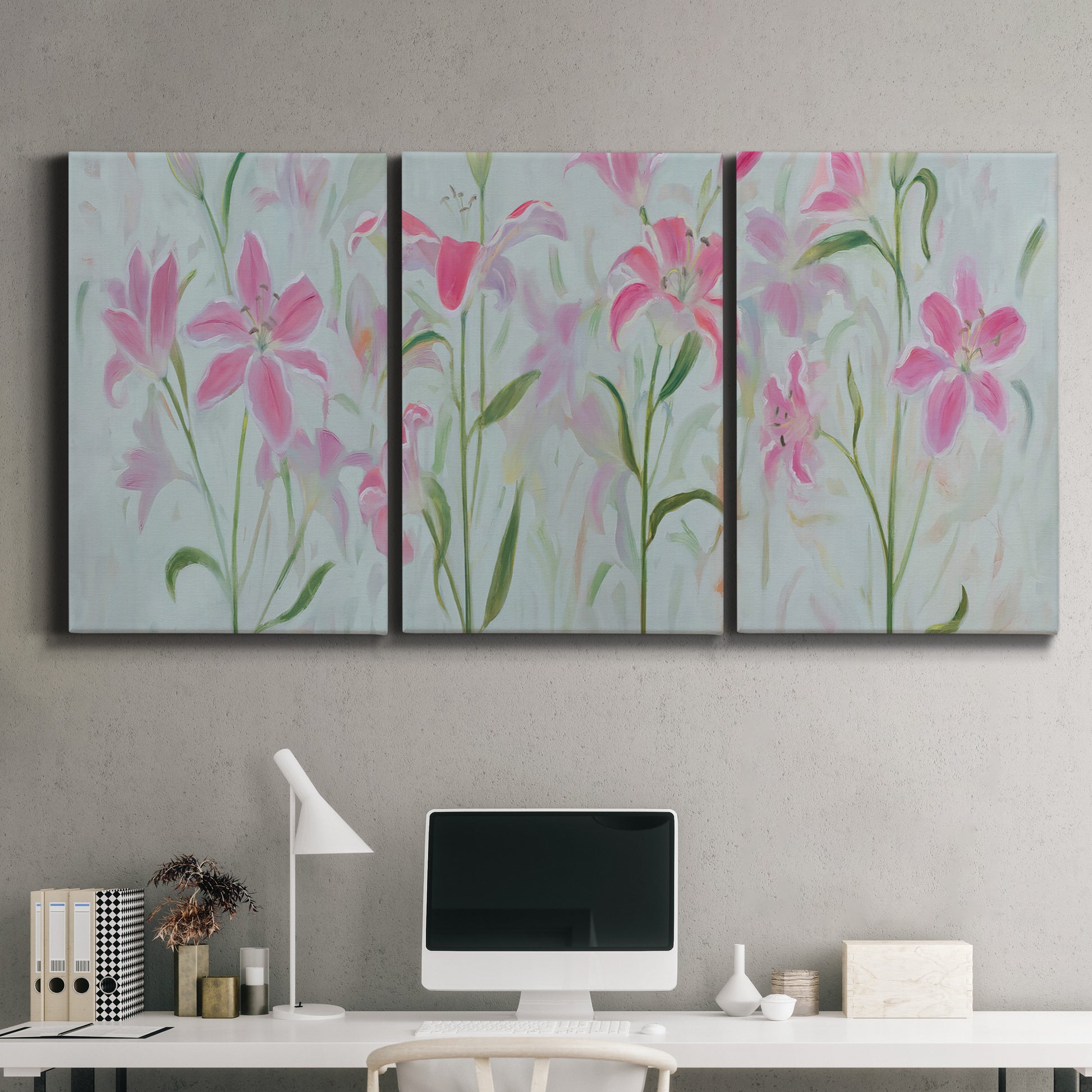 Three-panel canvas wall art featuring pink floral trio arrangement, displayed above a desk in a home office.