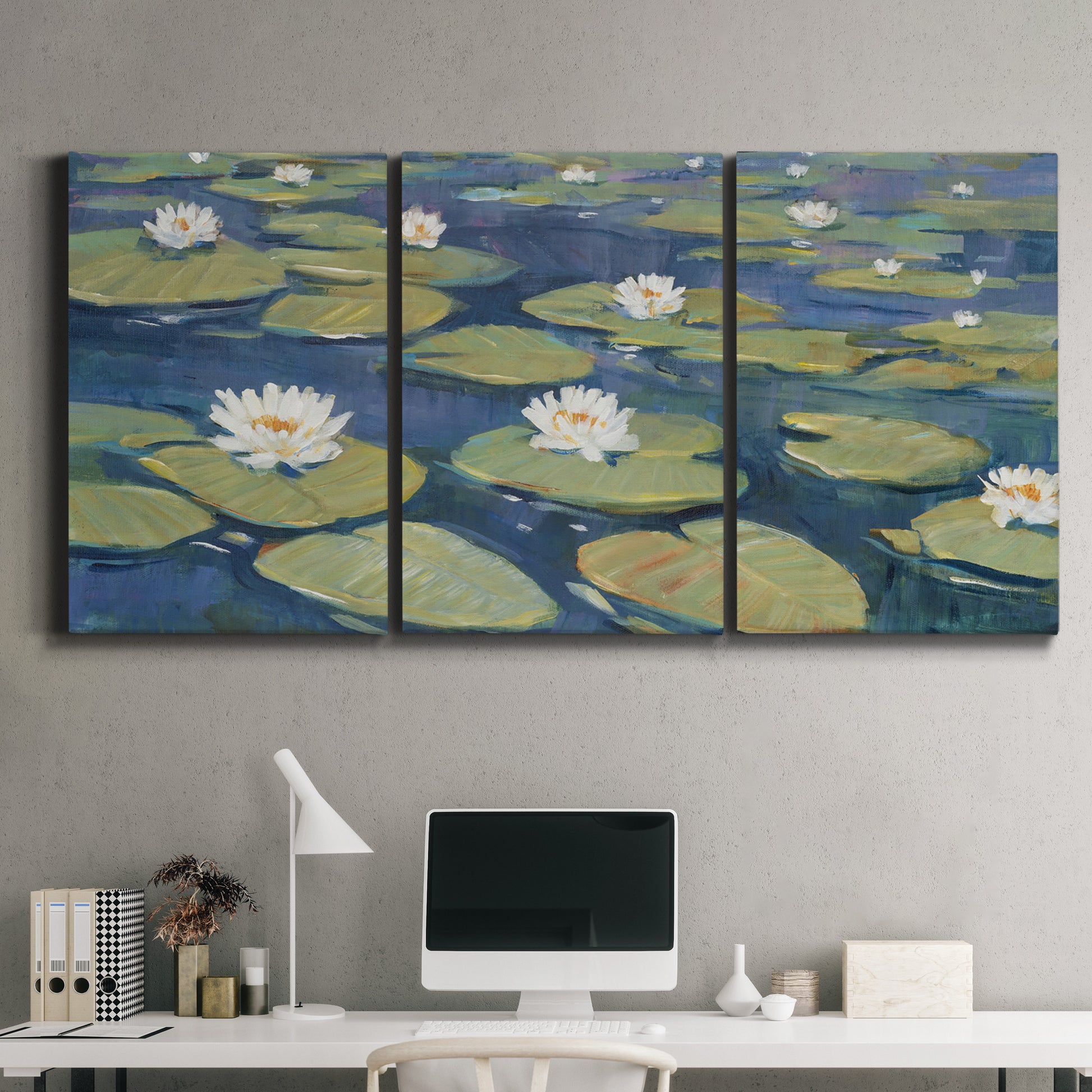 Three-panel canvas wall art featuring water lilies floating on pond, displayed above a desk in a home office.