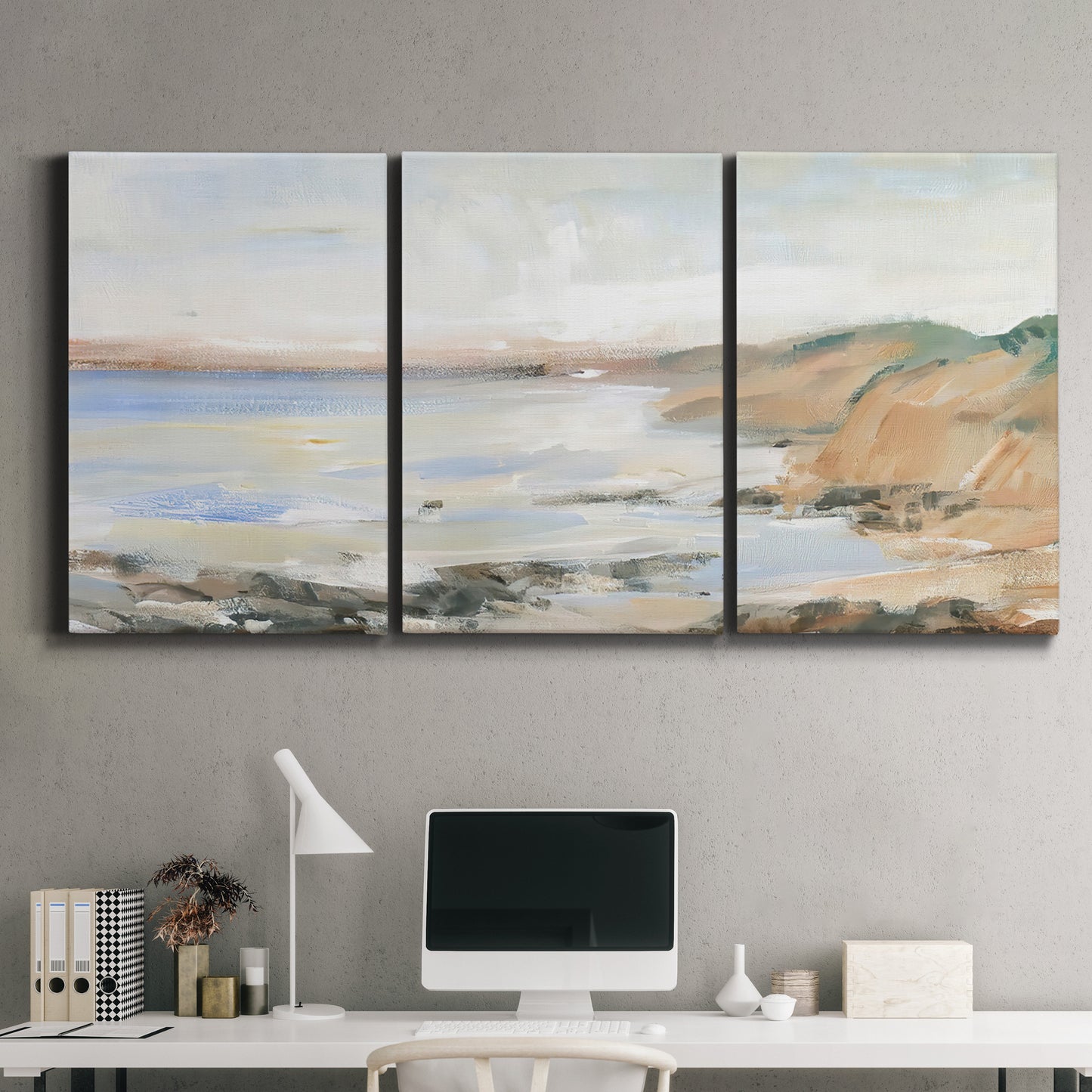 Three-panel canvas wall art featuring coastal shoreline landscape study, displayed above a desk in a home office.
