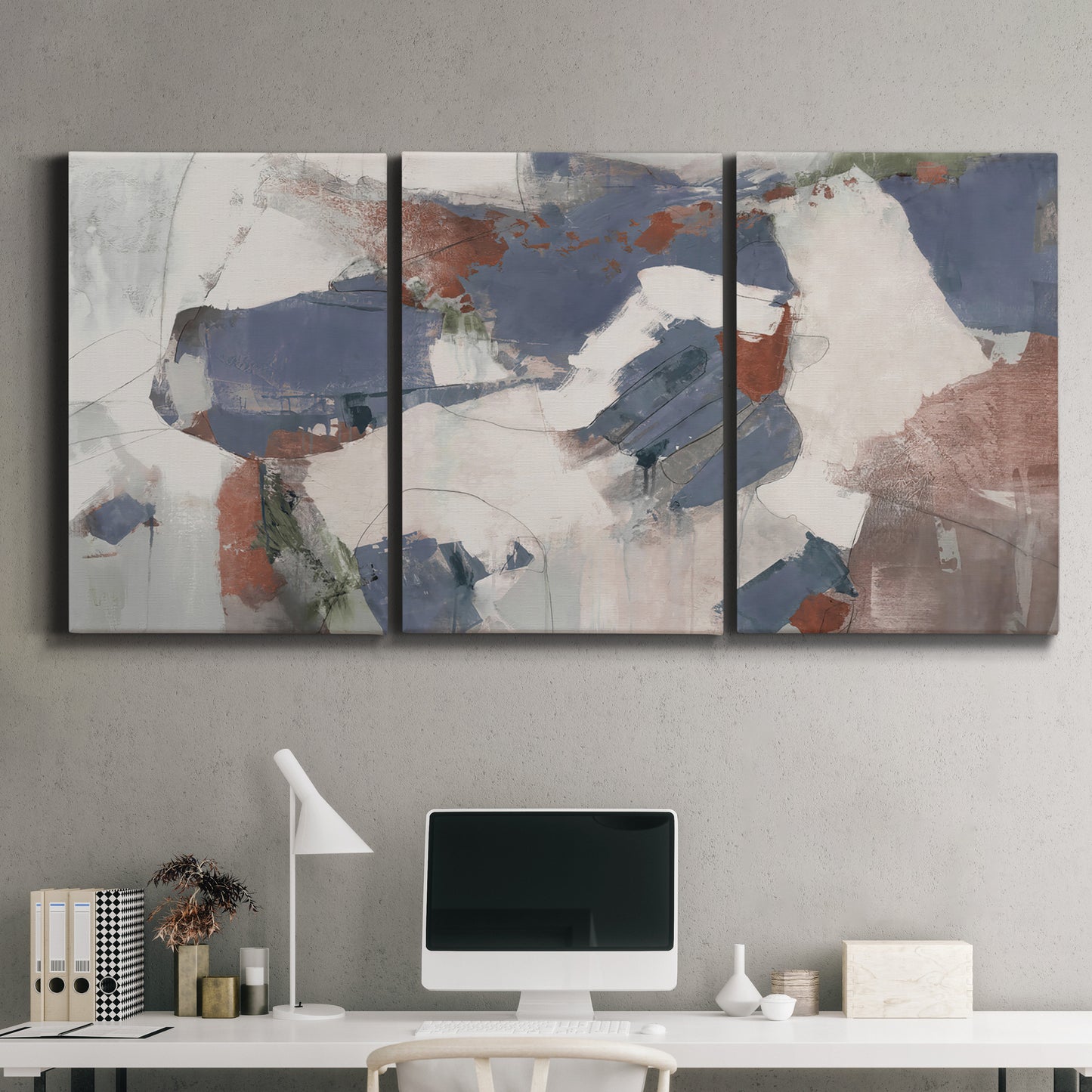 Three-panel canvas wall art featuring cool blue abstract layered composition, displayed above a desk in a home office.