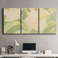 Three-panel canvas wall art featuring minimal verdant floral abstraction, displayed above a desk in a home office.