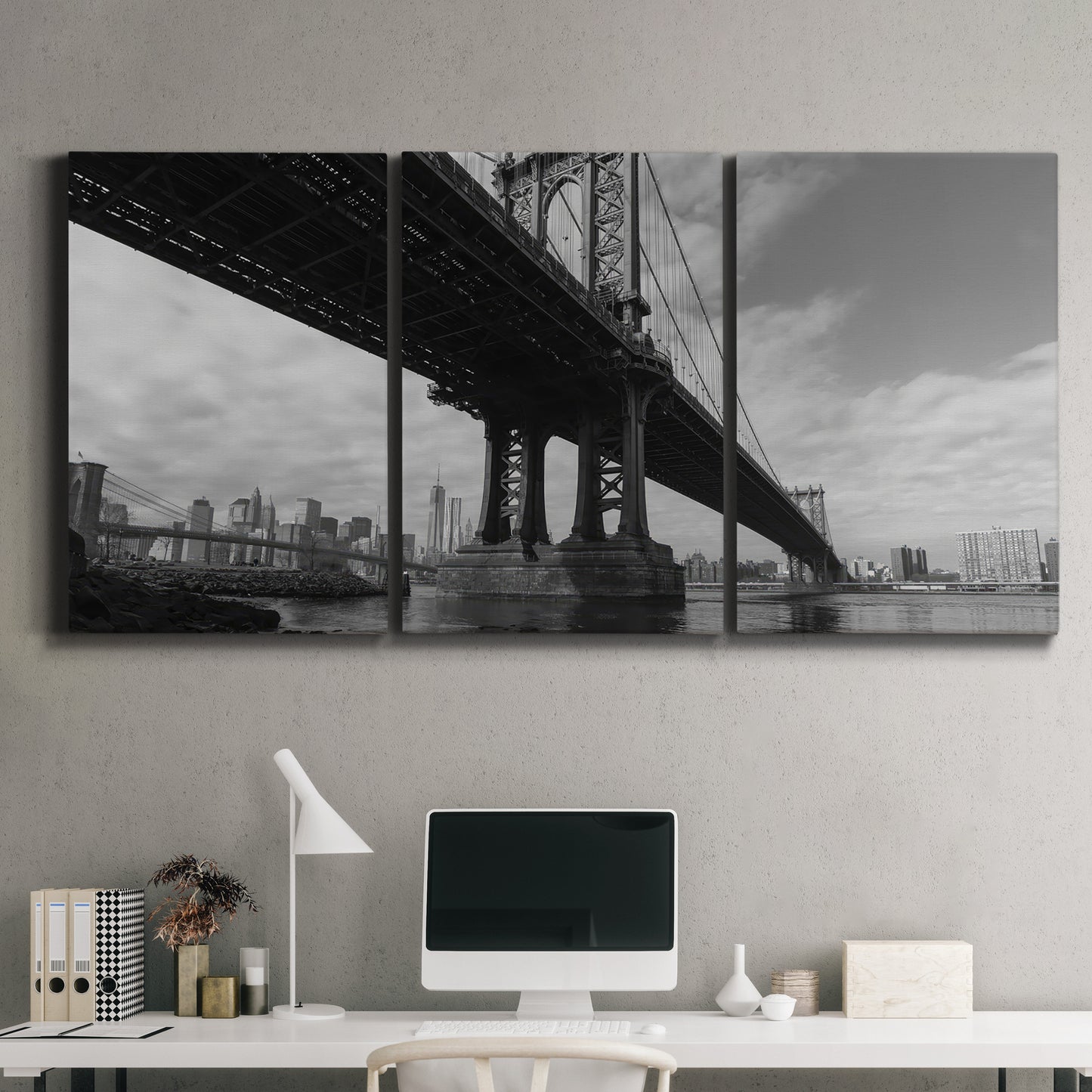 Three-panel canvas wall art featuring manhattan bridge industrial cityscape, displayed above a desk in a home office.