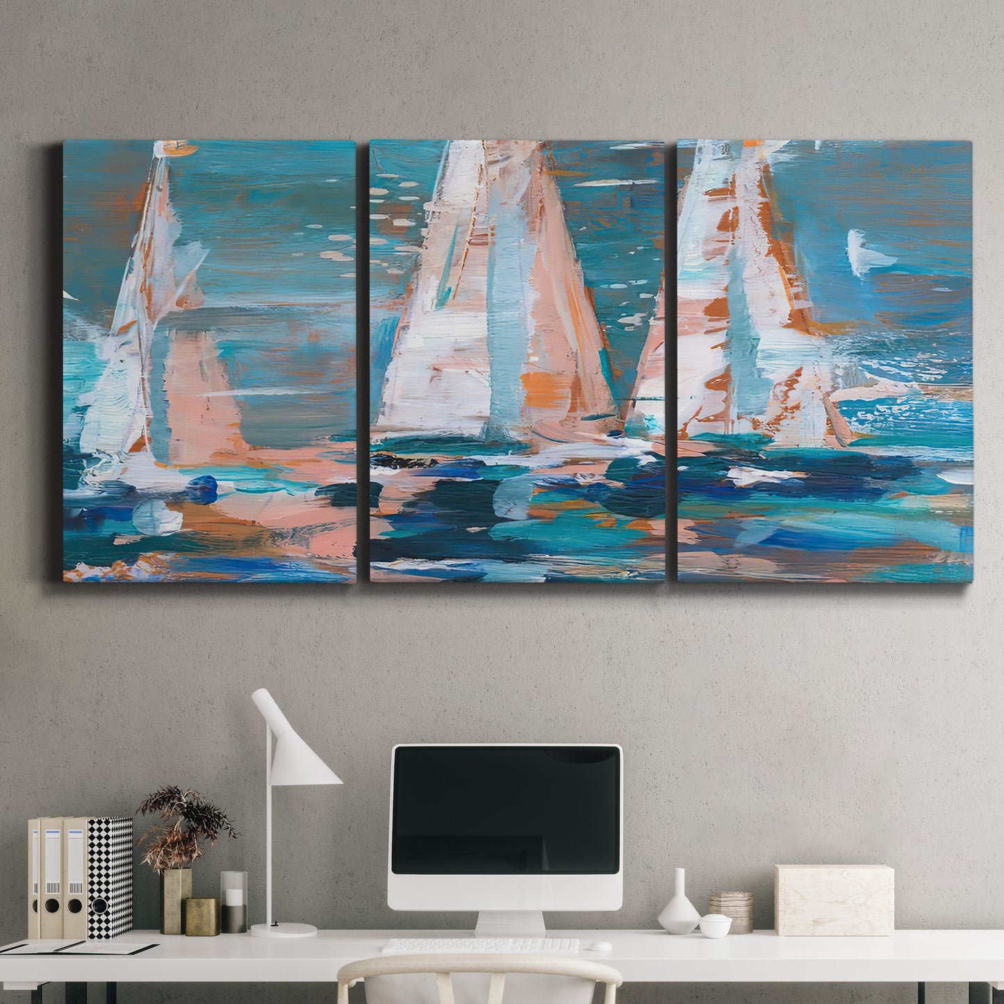 Three-panel canvas wall art featuring graphic pop style sailboats, displayed above a desk in a home office.