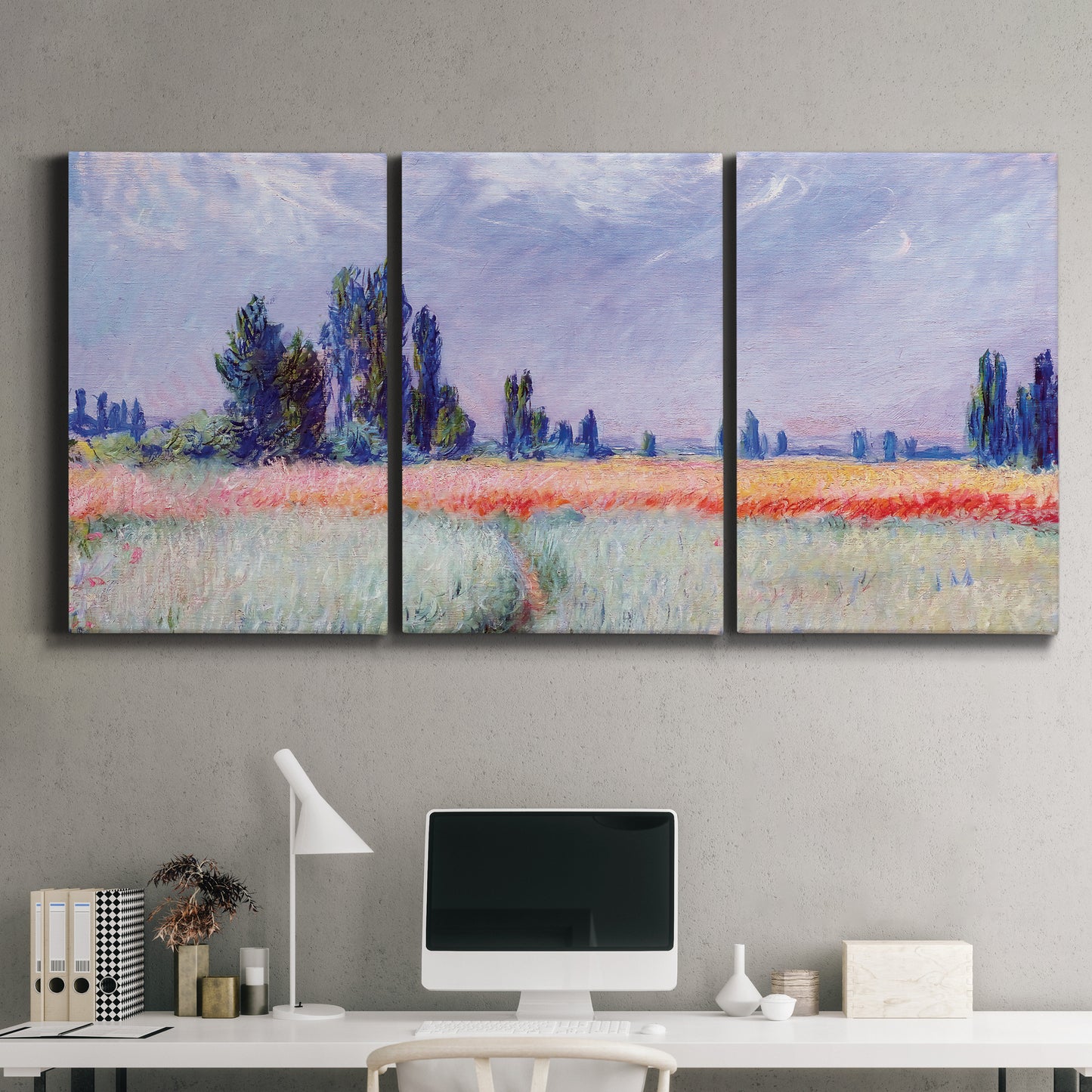 Three-panel canvas wall art featuring flowering field with poppies, displayed above a desk in a home office.