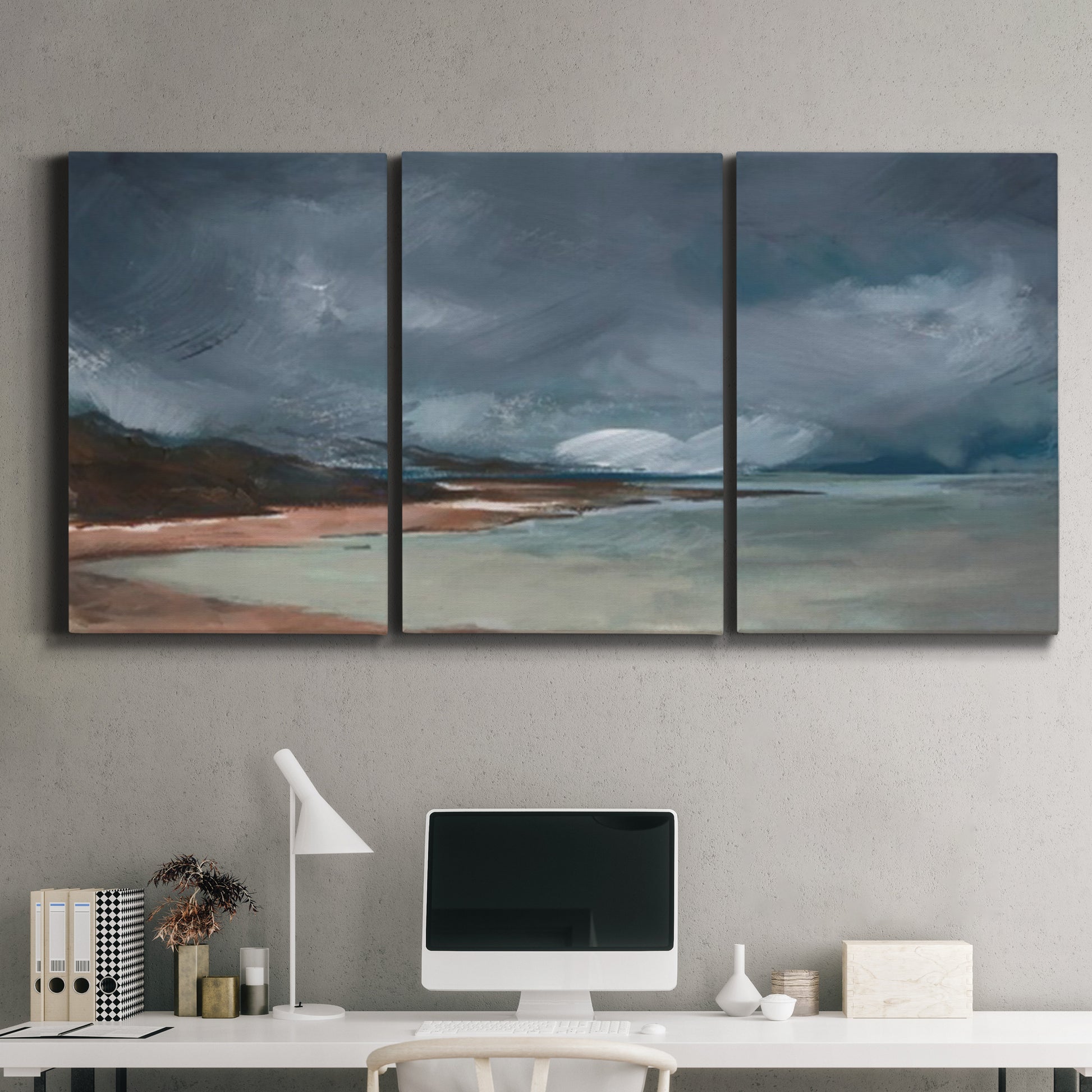 Three-panel canvas wall art featuring stormy sea glass toned coastline, displayed above a desk in a home office.
