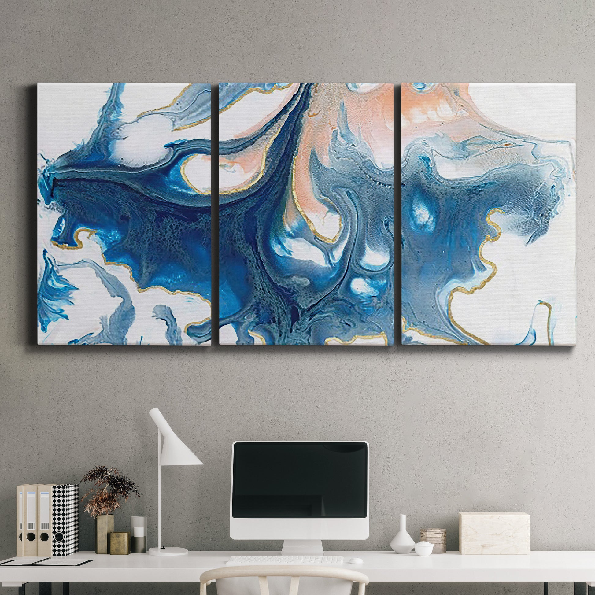 Three-panel canvas wall art featuring flowing blue abstract movement, displayed above a desk in a home office.