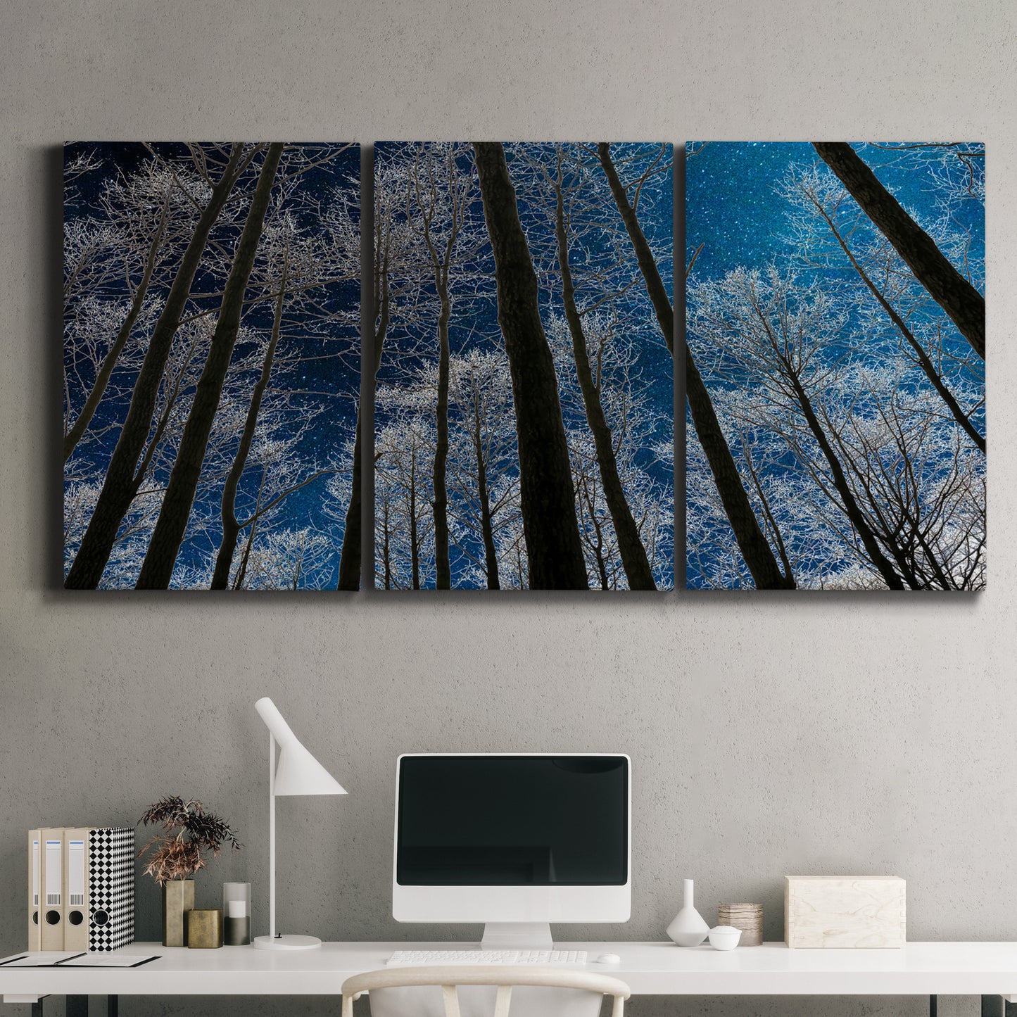 Three-panel canvas wall art featuring night landscape silhouette photography, displayed above a desk in a home office.