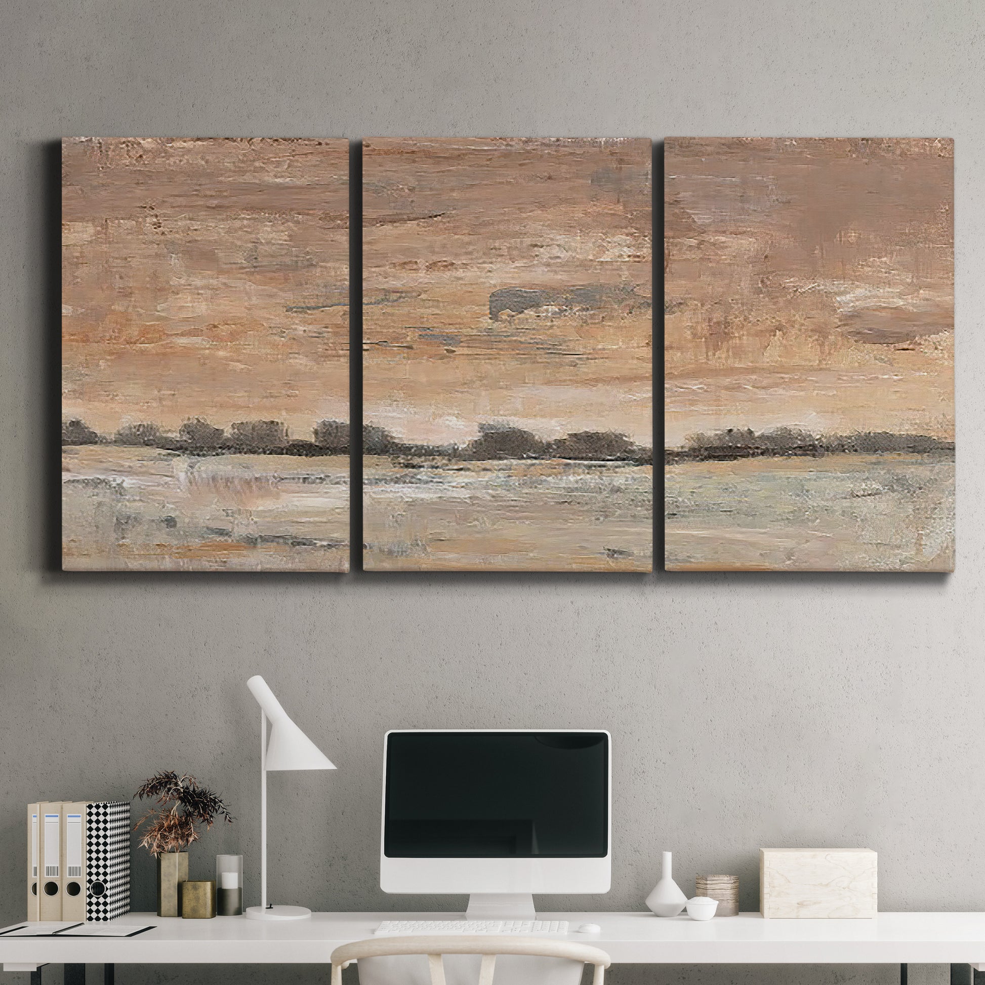 Three-panel canvas wall art featuring soft early evening landscape light, displayed above a desk in a home office.