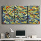Three-panel canvas wall art featuring colorful abstract river like motion, displayed above a desk in a home office.