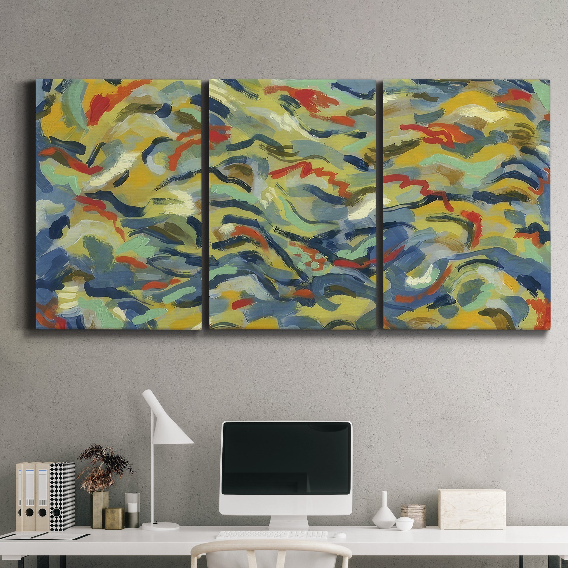 Three-panel canvas wall art featuring colorful abstract river like motion, displayed above a desk in a home office.