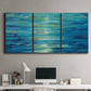 Three-panel canvas wall art featuring deep blue ocean water abstraction, displayed above a desk in a home office.
