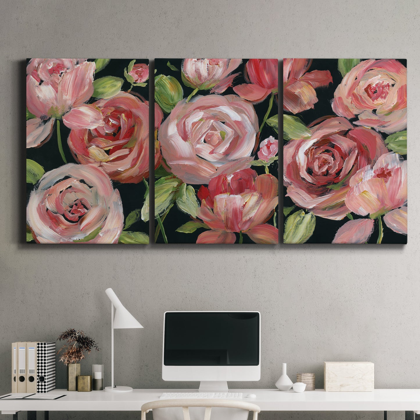 Three-panel canvas wall art featuring bold red floral abstraction, displayed above a desk in a home office.