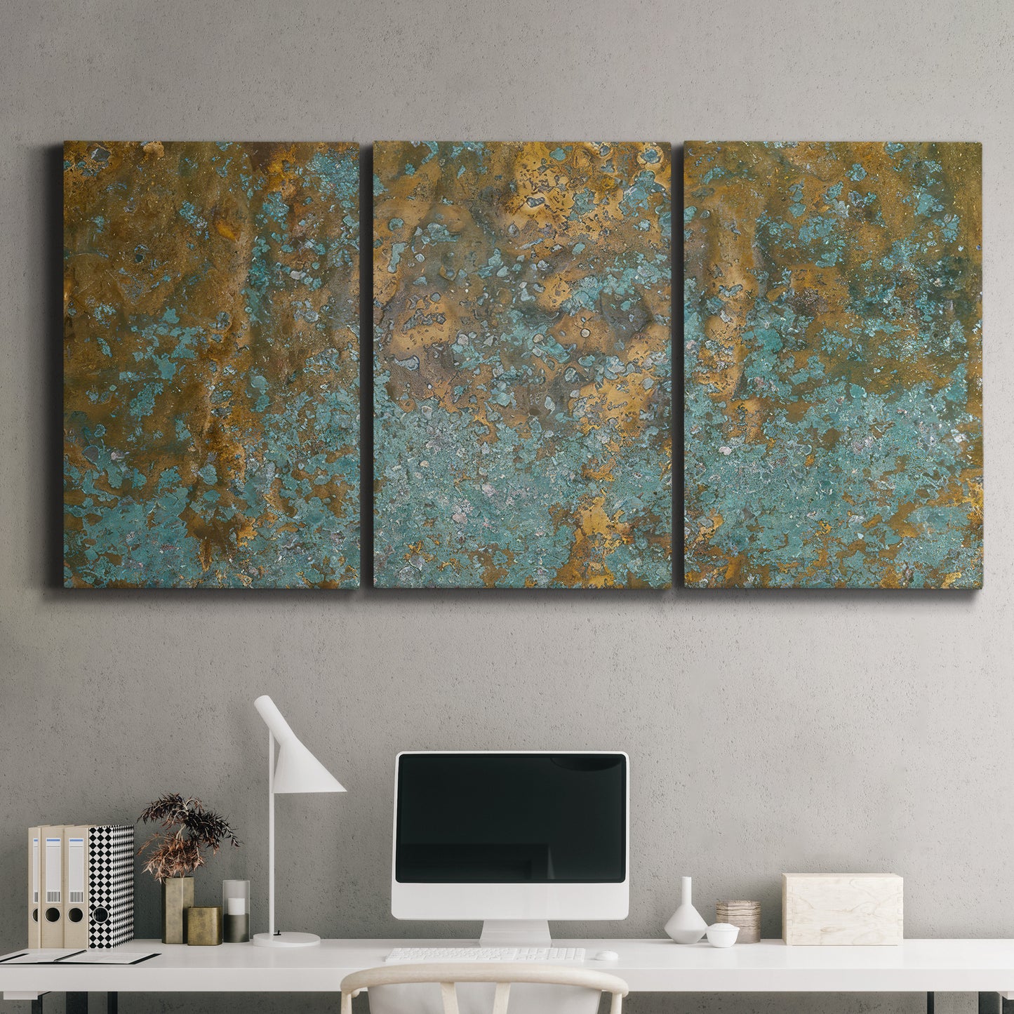 Three-panel canvas wall art featuring earthy copper toned abstract, displayed above a desk in a home office.