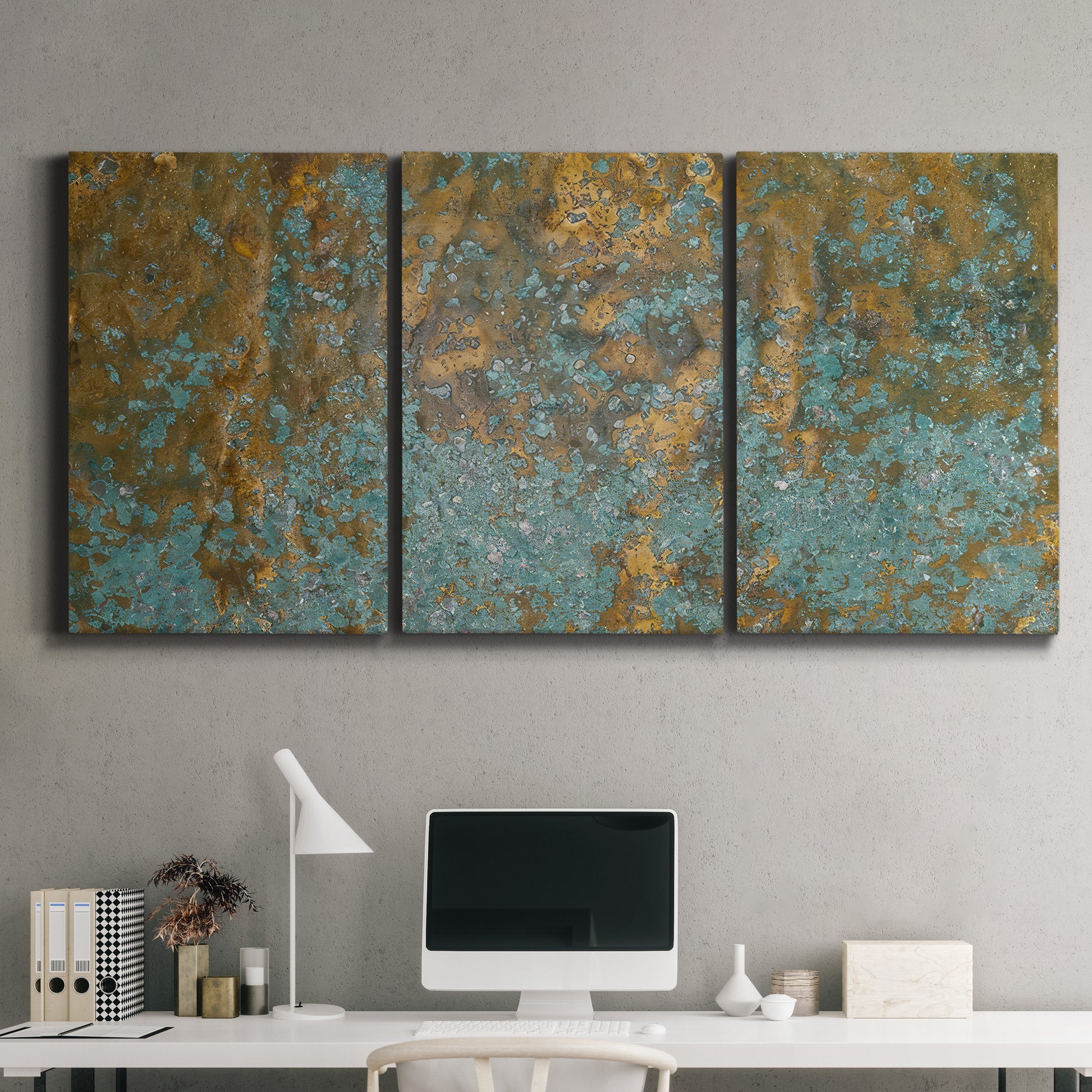 Three-panel canvas wall art featuring earthy copper toned abstract, displayed above a desk in a home office.