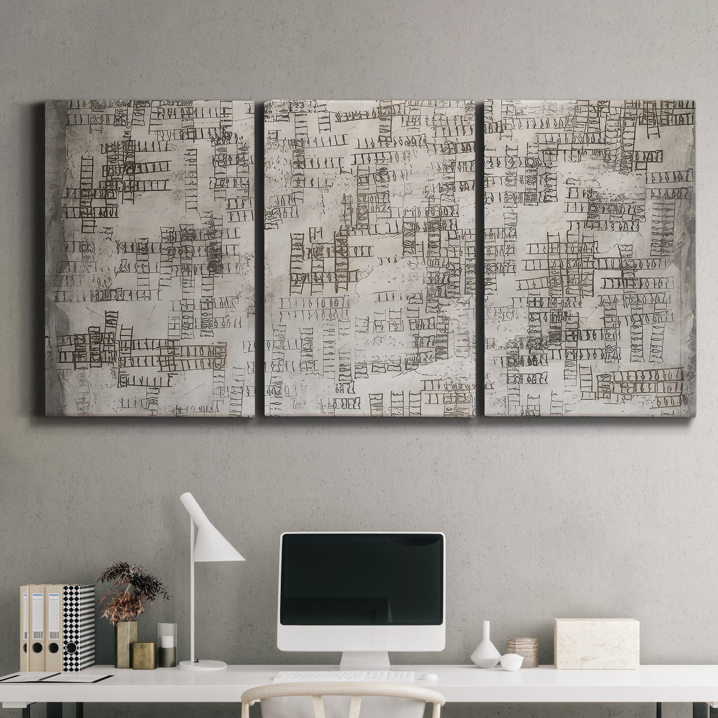 Three-panel canvas wall art featuring grid based geometric abstraction, displayed above a desk in a home office.