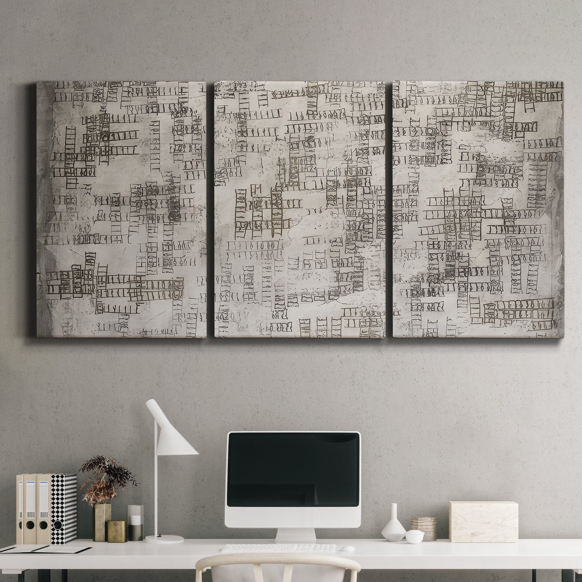 Three-panel canvas wall art featuring grid based geometric abstraction, displayed above a desk in a home office.