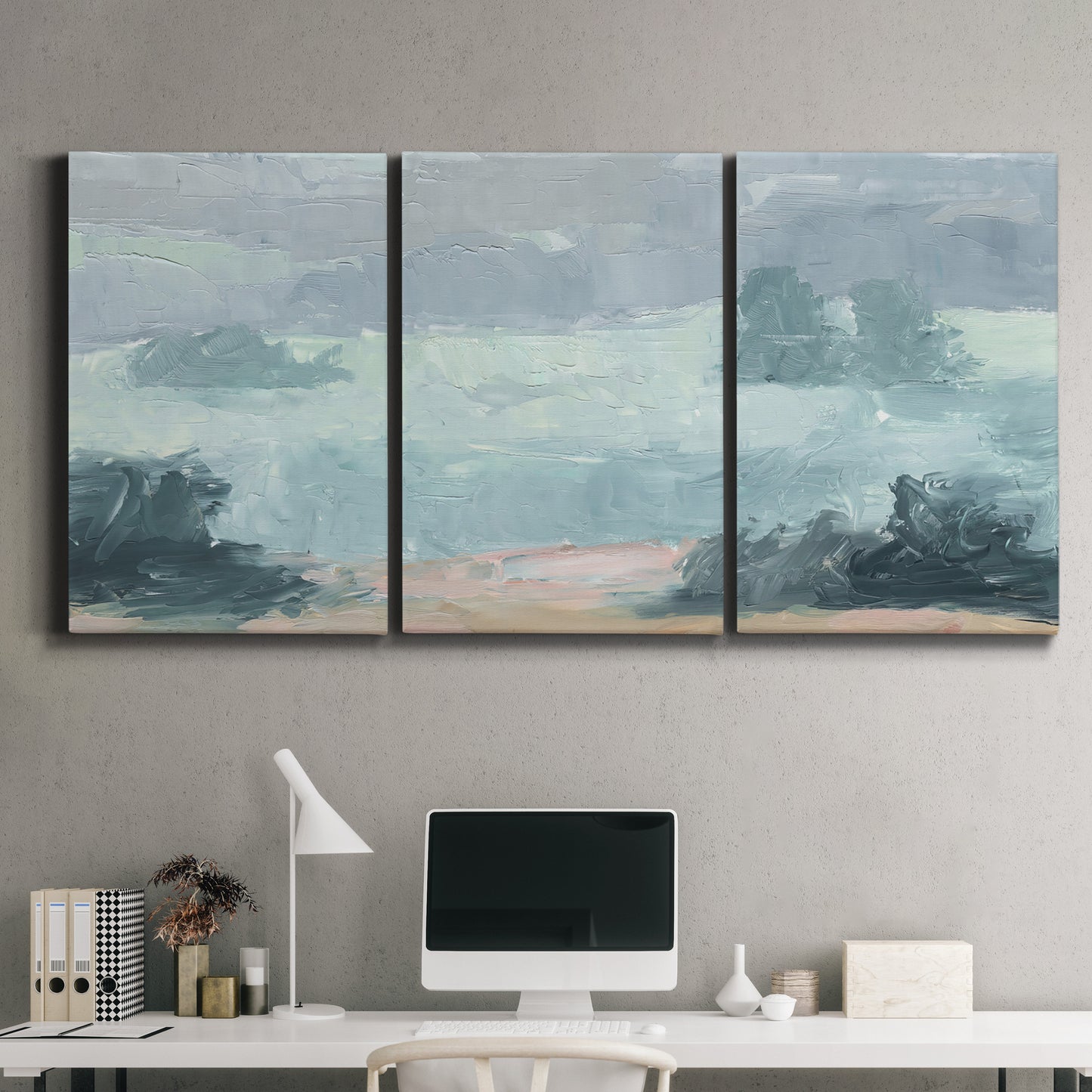 Three-panel canvas wall art featuring soft pastel valley landscape, displayed above a desk in a home office.