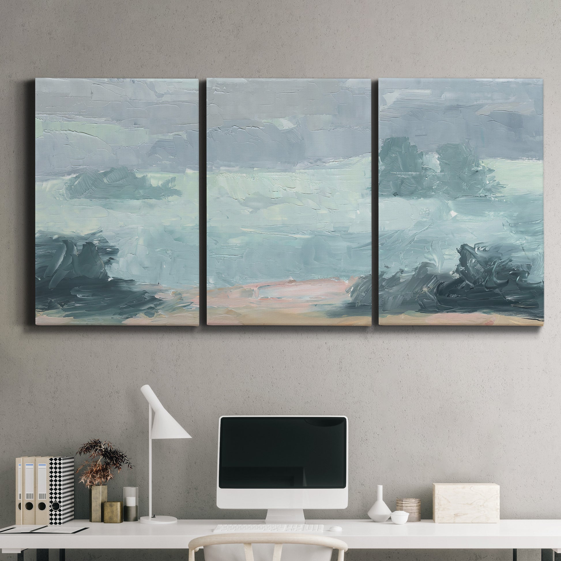 Three-panel canvas wall art featuring soft pastel valley landscape, displayed above a desk in a home office.