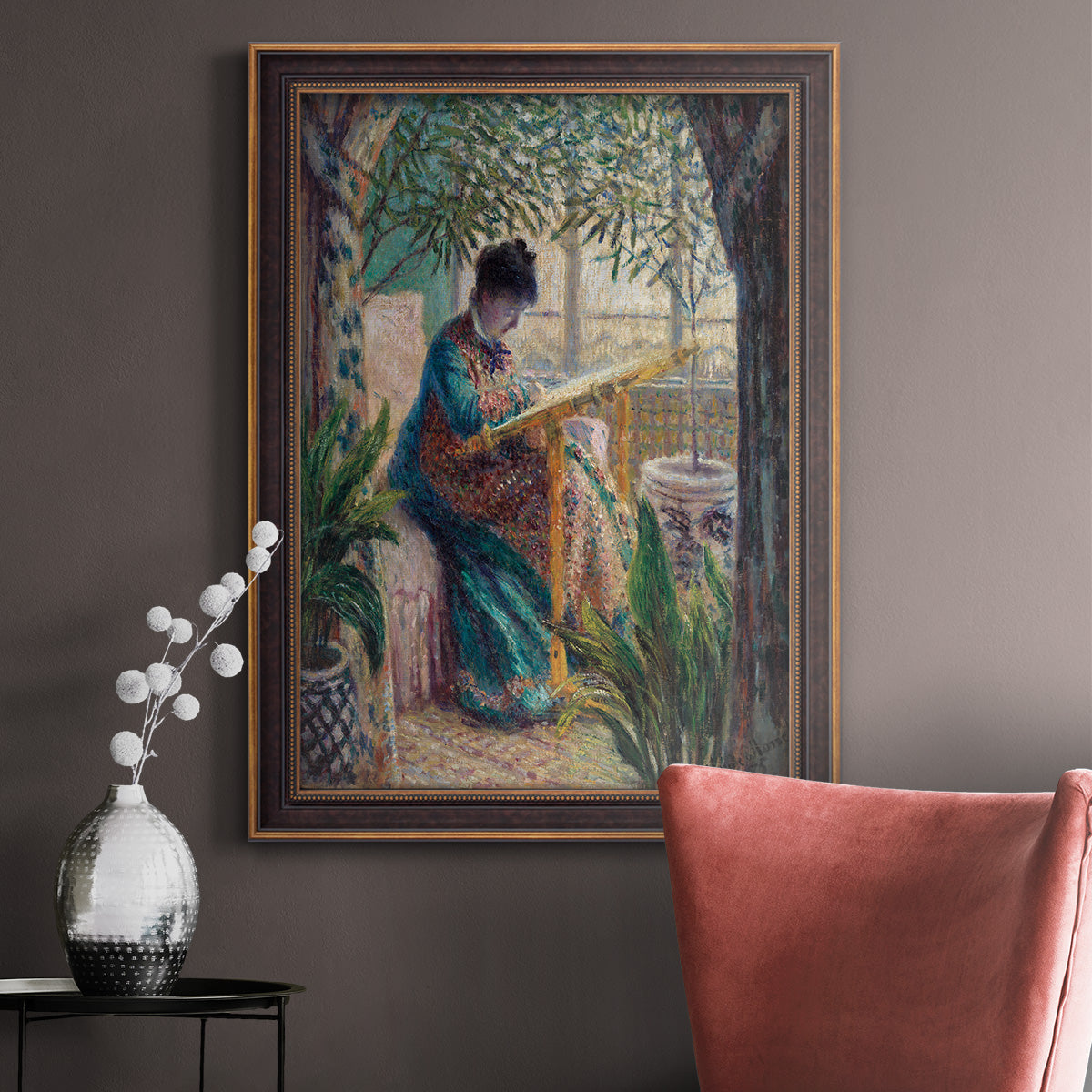 Impressionist portrait of Madame Monet sewing by Claude Monet in an ornate bronzed mahogany wood frame displayed in a neutral interior setting.