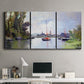 Three-panel canvas wall art featuring river view with boats and reflections, displayed above a desk in a home office.