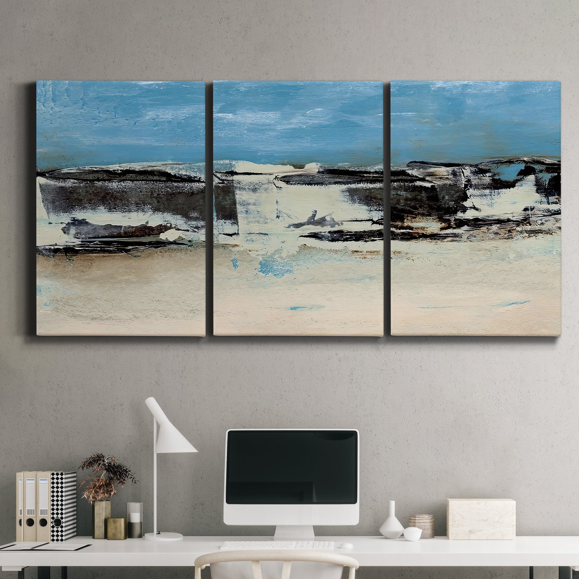 Three-panel canvas wall art featuring abstract bridge landscape in cyan, displayed above a desk in a home office.