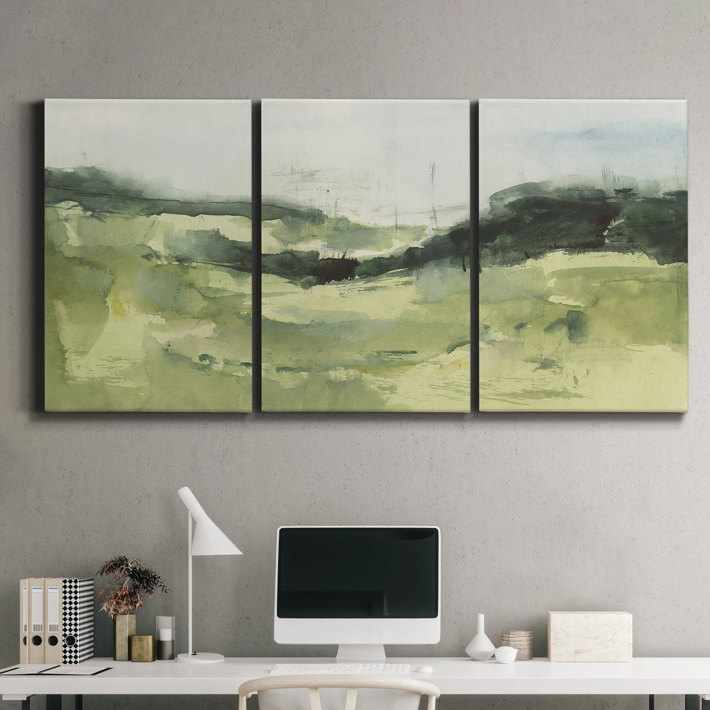 Three-panel canvas wall art featuring rolling hillside countryside landscape, displayed above a desk in a home office.