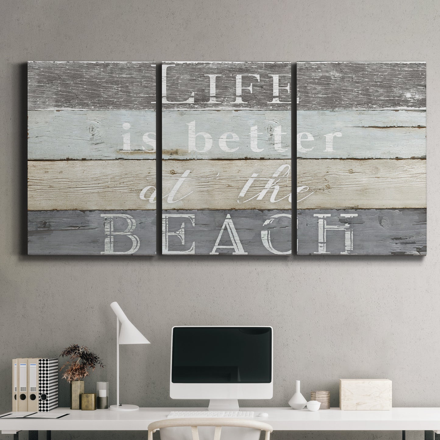 Three-panel canvas wall art featuring beach themed typography design, displayed above a desk in a home office.